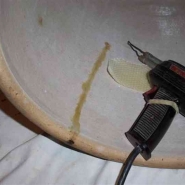 Crock repair using beeswax melted with a soldering iron. Photo by Gary Schu