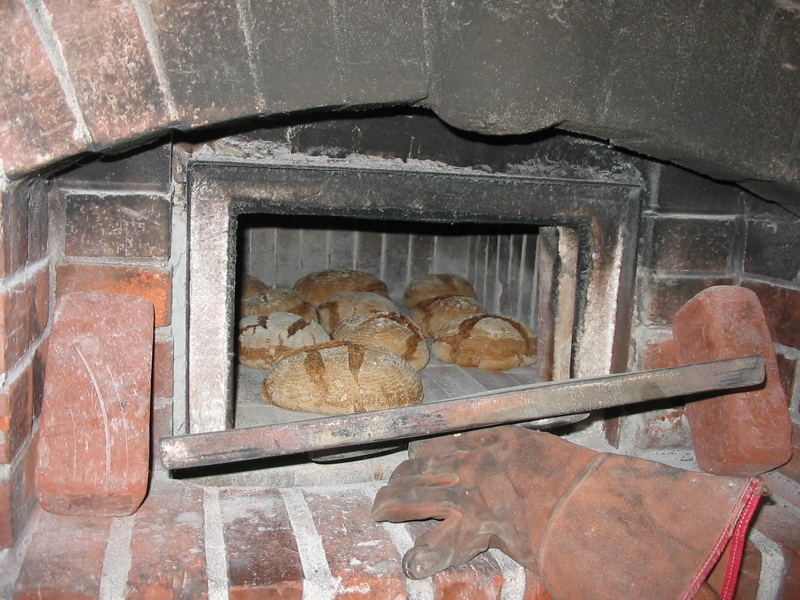 Bread ready to come out of Brian Thomas\' wood-fired oven.