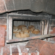 Bread ready to come out of Brian Thomas\' wood-fired oven.
