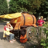 My friend Ellery, pictured at right, at a Kvass wagon in Lithuania. “The cart was busy as hell, and people were filling up empty soda bottles, glass jars, and thin plastic cups. It was about 5 cents a cup.”