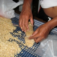 Filling a bag with beans.