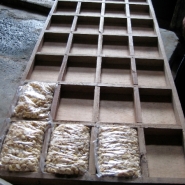 Filled bags placed in a form to square up their edges.